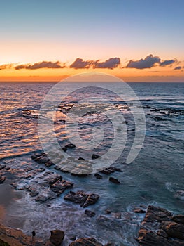 Aerial sunrise seascape with high tide and rock platform
