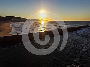 Aerial sunrise video over the ocean and the beach