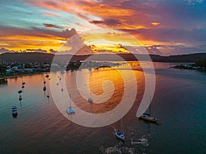 Aerial sunrise waterscape with boats, colour and clouds