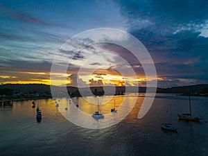 Aerial sunrise waterscape with boats, colour and clouds