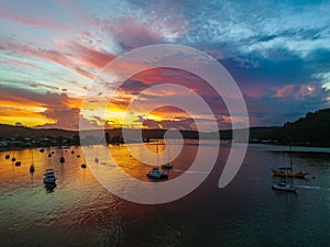 Aerial sunrise waterscape with boats, colour and clouds