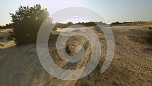 Aerial Sunset FPV Racing Drone Shot of the People on ATVs Quadrocycles in The largest desert in Europe, Ukraine -