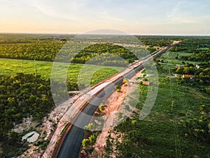 Aerial sunset landscape of road in the countryside during summer in Mato Grosso