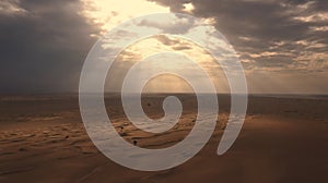 AERIAL. Sunset light shines across Great Sand Dunes at UAE. HDR dramatic sunset in desert.