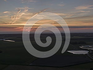 Aerial of sunset over agricultural meadowland and sea on the dutch island of Texel photo