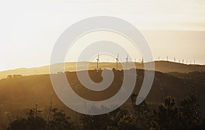 Aerial sunset panorama of renewable enegery windmill wind turbine farm park near Brantuas Costa da Morte Galicia Spain