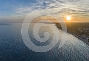 Aerial sunset seascape, of Praia Porto de Mos Beach and seaside cliff formations along coastline of Lagos city Portugal