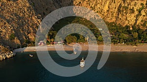 Aerial sunset view of Butterfly Valley in Oludeniz, Turkey. A mediterranean sea and beach between high cliffs