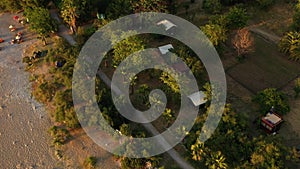 Aerial sunset view of camping in Butterfly Valley, Oludeniz, Turkey. A mediterranean beach with tents and bungalows