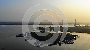 aerial sunset view of Can Tho bridge, Can Tho City with development buildings, transportation, energy power infrastructure