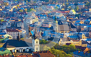 Aerial sunset view of historical old city district with churches, cathedrals and houses roofs in Lviv, Ukraine