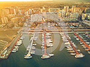 Aerial sunset view of the marina of La Pobla de Farnals, Valencia, Spain. Boats moored in the harbor at sunset of the