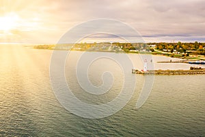 Aerial sunset view of wawatam lighthouse at the harbor of St. Ignace, Michigan in the Straits of Mackinac