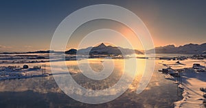 Aerial sunset view of winter landscape of frozen rocky sea beaches. Lofoten islands Norway