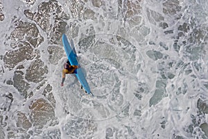 Aerial from a surfer going to surf in the atlantic ocean