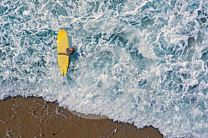 Aerial from a surfer going to surf in the ocean