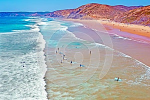 Aerial from surfers getting surfing lessons at the atlantic ocean