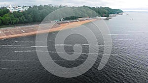 Aerial survey, top view. A barge with the ship sand is floating on the river.