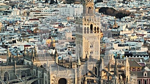 Aerial tele shot of gothic cathedral in Seville, Andalusia, Spain. Famous Giralda bell tower, Sevilla - capital city