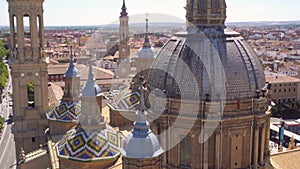 Aerial tilt shot view of dome and roof of famous landmark Basilica Our Lady of the Pillar. Zaragoza, Spain.