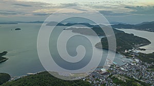 Aerial time lapse over coastal islands and town on Shodoshima at dawn