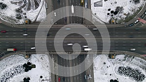 Aerial timelapse of the cars passing by on a highway and a bridge at winter