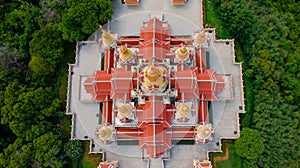 Aerial top angle drone view closeup above pagoda temple of Wat PraMahathadchedi Pakdeeprakad or Tang Sai temple on mountain forest