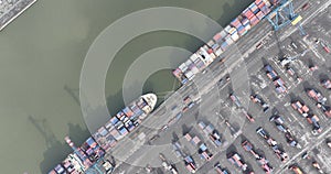 Aerial top down of container shipping, port of Antwerp, Belgium. Dock with ships and containers. Merchandise and