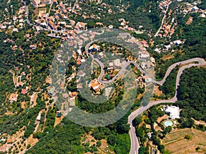 Aerial top down daytime view of Italy. Streets of city with hotels and restaurants are located on rocky seashore. Danger curve