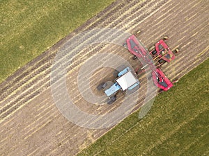 Aerial top down drone photo. Agriculture tractor with seeding irrigation system on parking. Russia.