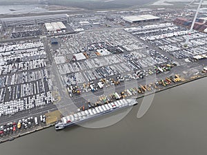 Aerial top down drone views of transportation of vehicles over seas from a sea port terminal, specifically the Zeebrugge