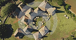 Aerial top down Indonesia farmland with ornated roofs houses at Kodi village landscape, Sumba Island photo