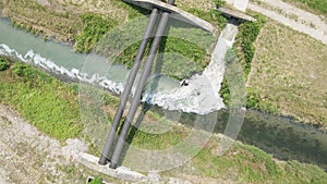 Aerial top down of industrial waste water mixing with water canal water