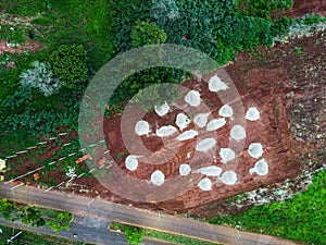 Aerial top down of piles of concrete in clay field Tangara da Serra in Mato Grosso