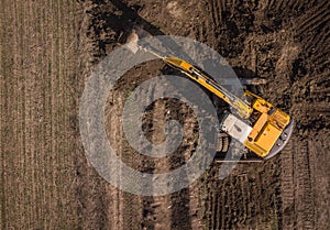 Aerial top down shot of excavator in work.