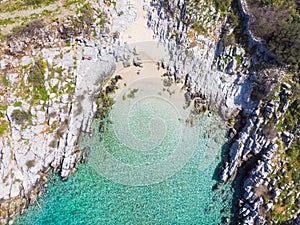 Aerial top down view beautiful beach and water bay in the greek spectacular coast line. Turquoise blue transparent water, unique
