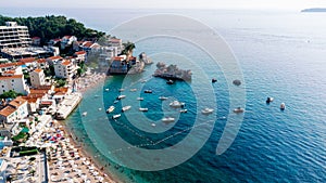 Aerial top down view of boat dock and yacht port in Montenegro. White private motor boats are moored to pier on Adriatic sea coast