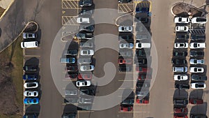 Aerial top down view of car moving and standing on parking lot