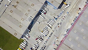 Aerial top down view of Cargo truck Containers and Distribution Warehouse.