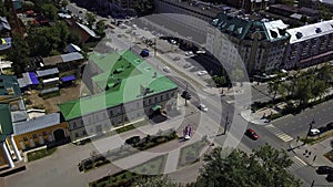 Aerial top down view of cars driving on street. Clip. Urban landscape with buildings and streets. photo