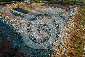 Aerial top down view of city garbage dump. Pile of plastic trash, food waste, landfill