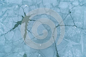 Aerial Top-Down View of Cracked, Broken, and Melting Ice on a Water Surface