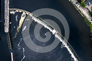 Aerial top down view on a dam and lock system. Water level management. Athlone, Ireland