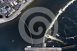 Aerial top down view on a dam and lock system. Water level management and small boat transportation. Athlone, Ireland