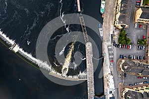 Aerial top down view on a dam and lock system. Water level management and small boat transportation. Athlone, Ireland