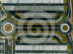 Aerial top down view of empty parking lot and two roundabouts