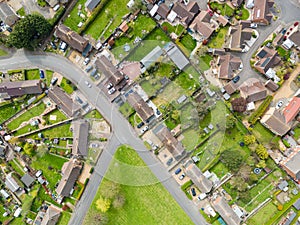 Aerial top down view of mostly semi detached houses seen in a typical English village.