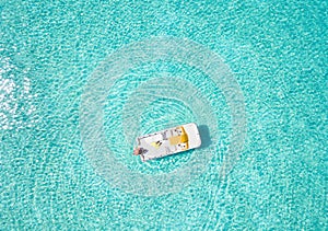 Aerial top down view of a pedalo boat with a girl