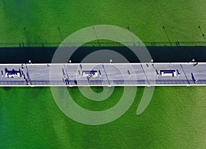 Aerial top down view on pier at sea shore with Tourists and sunbathers photo