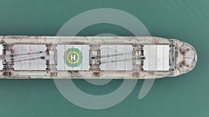 Aerial top down view of rdry cargo ship. Bulk carrier cargo vessel. Ship logistic and transportation business industry.